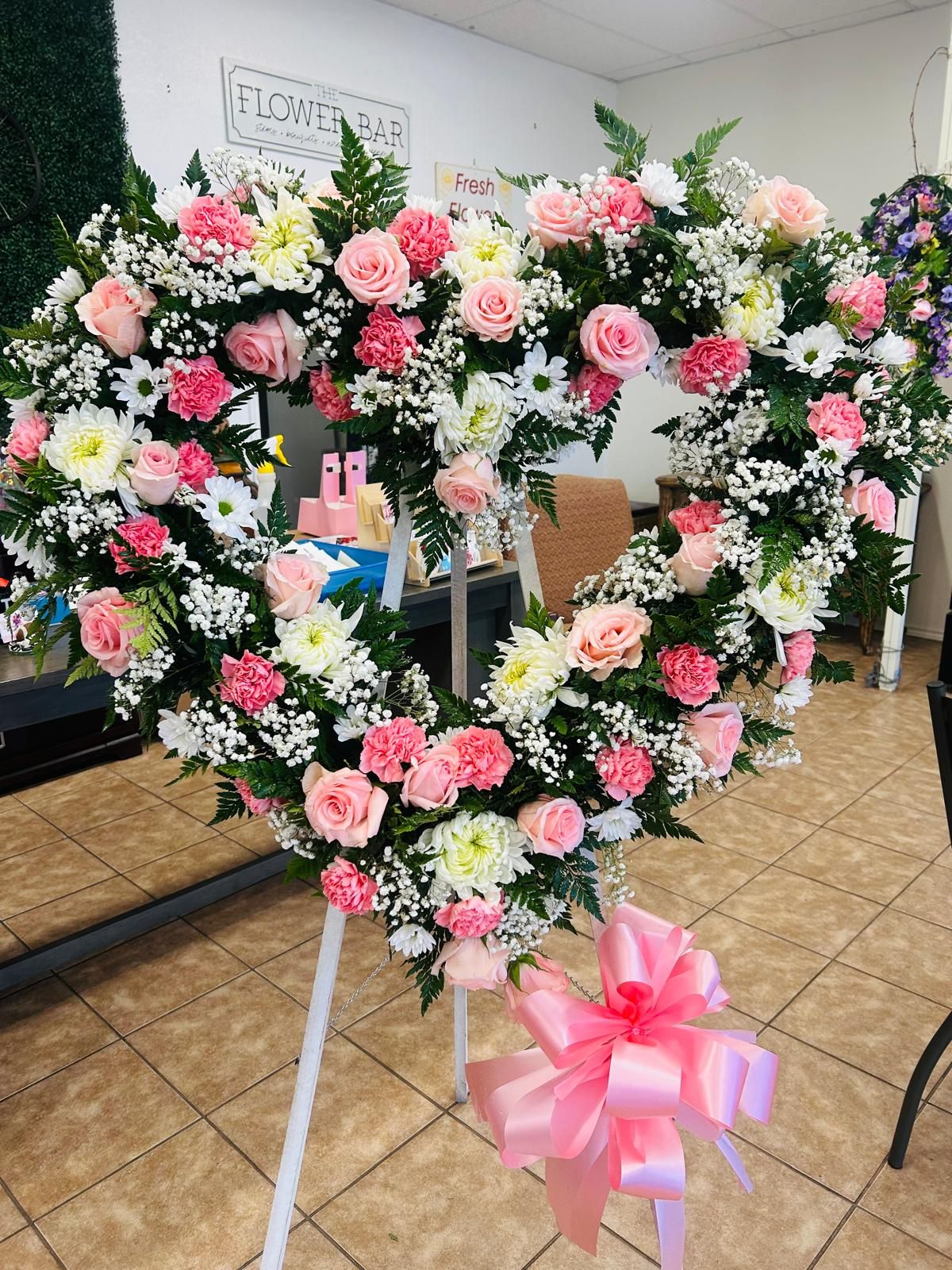 Heart-shaped standing sympathy wreath with pink roses, carnations and white mums, hand-made in our RGV studio