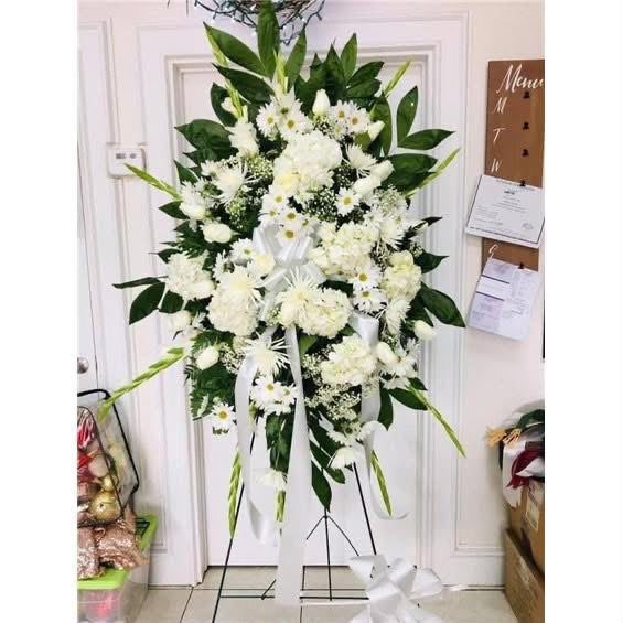 All-white funeral standing spray with mums, daisies and gladiolus for an RGV funeral service