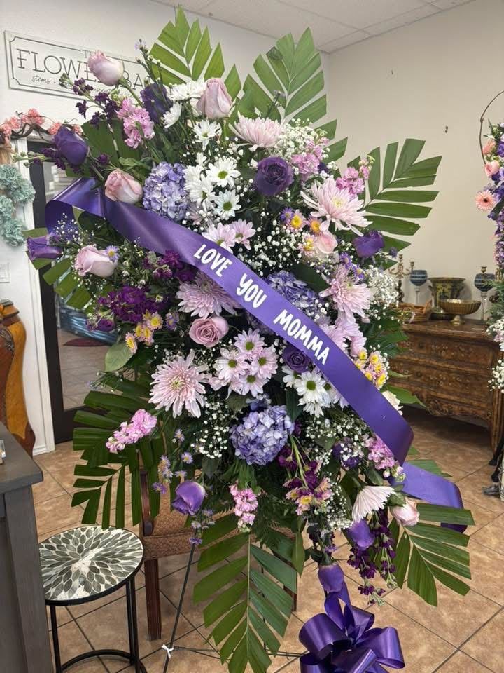 Lavender and purple standing sympathy spray with roses, hydrangea and stock, made for an RGV family