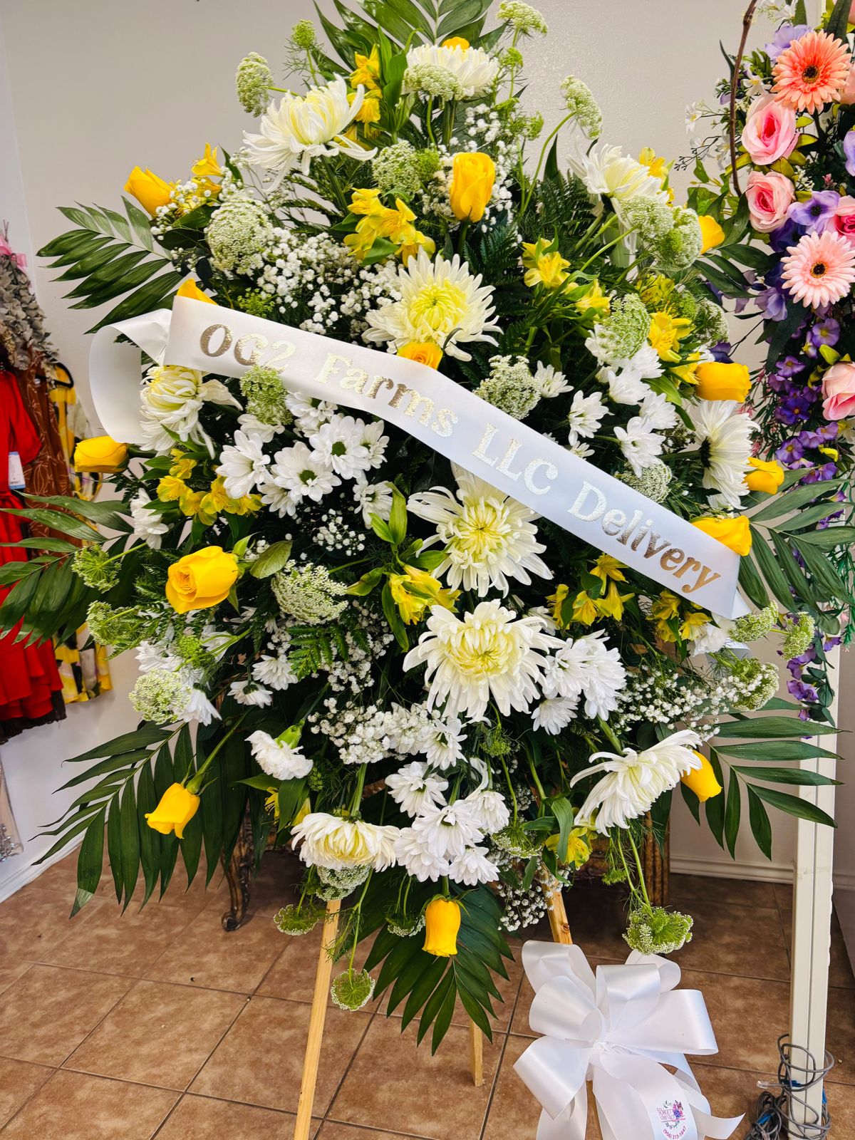 Yellow rose and white chrysanthemum funeral standing spray with personalized ribbon